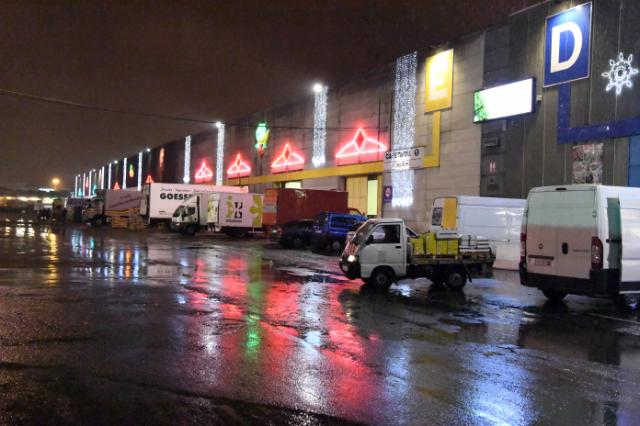 Trucks loading and unloading dock at night